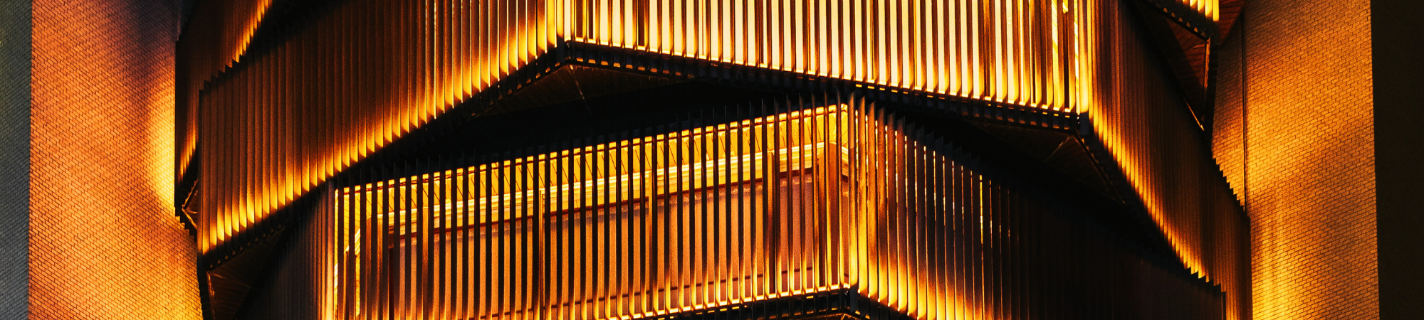 A geometric building with orange lighting